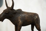 Close-up of the vintage African buffalo sculpture's textured copper body with dark patina.