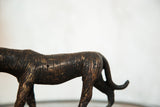 Detailed dark copper stripes on the vintage African tiger sculpture's mid-section.