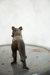 Vintage African tiger sculpture, back view showing aged copper texture and patina.