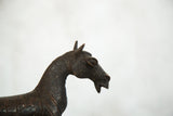 Detailed copper zebra sculpture, showing its head, ears, and textured neck.