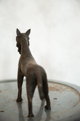 Rear view of detailed vintage African copper zebra sculpture with textured body.