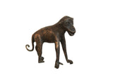 Vintage African monkey sculpture made of copper, featuring a dark, textured patina finish.