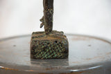 Dark copper base of vintage African rooster, rich green verdigris patina, rough texture and voids.