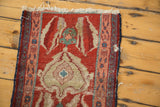 Heavy tatter and worn pile at the corner of a small antique Serapi collector rug.