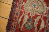 Storied wear on a late 19th-century Serapi rug, with exposed foundation and shell-like motifs.