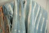Close-up of indigo African textile, showing hand-dyed patterns and a characterful edge.