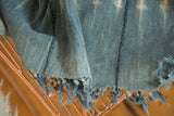 Collectible vintage batik indigo African textile, frayed tassels, and dark stitched seams.