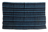 Collectible vintage hand woven African indigo throw with deep and muted blue stripes.