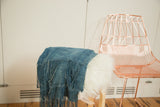 Supple hand-woven Denim Mossi Indigo textile, with its distinctive fringed edge.