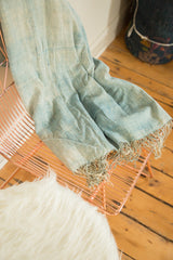 Supple hand-woven African indigo textile with unique textured weave and fringed edge.