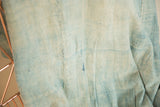 Hand-woven Mossi indigo textile with natural dye variations and a subtle mark.