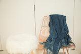 Vintage denim indigo African textile throw, highlighting its hand-woven texture and fringed edges.