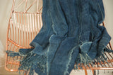Supple, hand-woven denim indigo African textile throw with textured fringes.