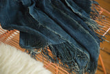 Deep indigo African textile throw featuring its hand-woven texture and fringed edge.