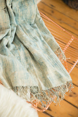 Fringed bottom edge of a collectible vintage indigo African textile.