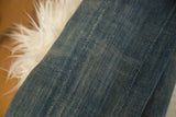 Textured hand-woven vintage African indigo textile, subtle blue variations.