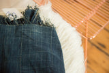 Hand-woven denim indigo African textile, featuring visible texture, color variations, and seam.