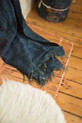 Vintage denim blue Mossi Indigo African Textile, its woven texture and frayed edges.