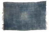 Vintage hand-woven African indigo textile throw, rich denim blue, horizontal bands, frayed edges.