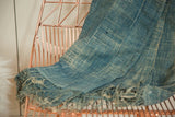 Textured hand woven African indigo throw with subtle stripes, frayed edge, and vintage character.