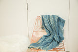 Vintage hand woven indigo textile showing subtle geometric patterns and soft texture.