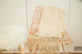 Natural beige hand woven cotton African textile throw showing fabric texture.