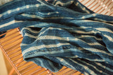 Textural detail of draped Batik Indigo African textile with hand-dyed blue and white stripes.