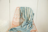 Draped handwoven African indigo textile with unique cream batik stripes.