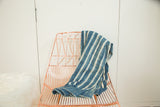 Textured hand-dyed indigo African throw with irregular cream and blue vertical stripes.