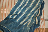 Hand woven indigo blue African textile with dashed off-white batik stripe pattern.
