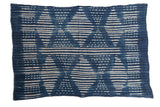 Collectible hand woven African indigo textile throw, deep blue and cream geometric patterns.