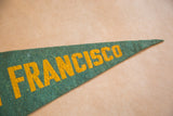 Partial 'NCISCO' yellow lettering on vintage green felt flag tip.