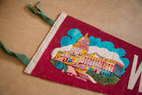 Detail of the vintage felt flag banner with colorful U.S. Capitol imagery and green ties.