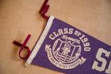 Purple felt pennant with 'Class of 1990' text, inmate illustration, and red ties.