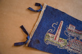 Left edge of vintage Boston felt flag, showing blue ties, beige binding, and age-related stain.