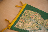 Green felt Delaware Water Gap flag, featuring yellow binding, ties, and graphic detail.
