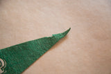 Pointed green felt tip of the Delaware Water Gap flag showing minor wear.