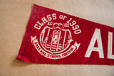 Detail view of red felt Class of 1990 Alcatraz flag, showing white text and prisoner graphic.