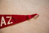 Vintage red felt pennant showing white 'AZ' letters and a creased, frayed tip.