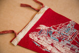 Close-up of Norfolk Virginia felt flag's cream binding and textured red tie.