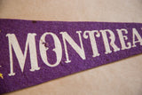 Vintage purple felt pennant, off-white 'MONTREAL' text with visible texture.