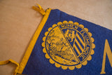 Marquette University felt pennant, showing the yellow crest and NUMEN FLUMENQUE text.