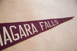 Burgundy felt pennant detail, showing 'NIAGARA FALLS' in aged cream letters.