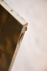 Close-up of the antique oceanscape painting's canvas edge, showing tacks and aged texture.
