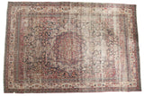Antique Kermanshah carpet, oversized scalloped medallion, scrolling floral field, cochineal red, navy, and camel.