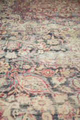 Antique Kermanshah carpet, mostly even wear to foundation revealing faded red and blue scrolling florals.