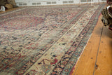 Antique Persian Kermanshah carpet border, cochineal red, navy scrolling florals, and mostly even wear.