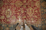 Distressed vintage Agra carpet texture, faded cinnabar red field with scrolling floral vinery.