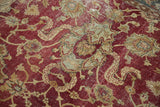 Distressed vintage Agra carpet texture, showing faded cinnabar red patterns and pale bronze vinery.