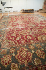 Vintage Distressed Agra rug with faded cinnabar red field and teal green border.